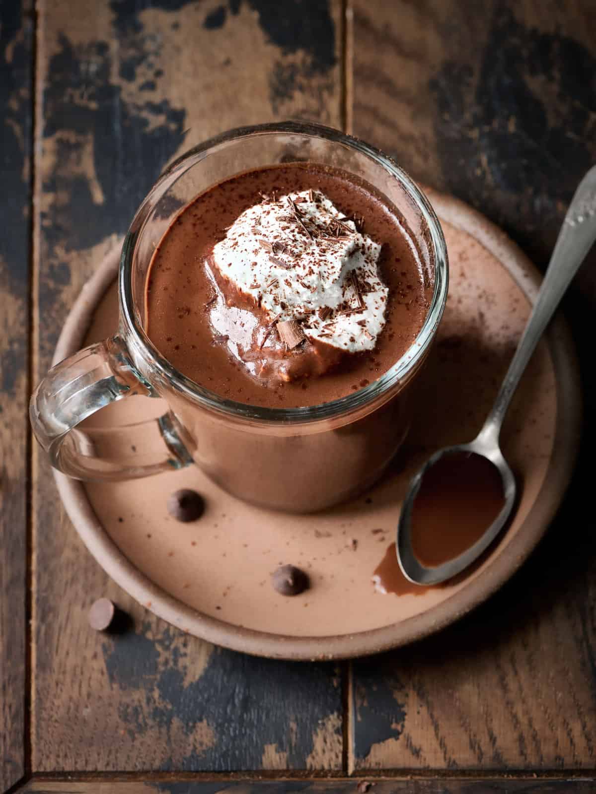 Overhead view of single mug of hot chocolate on wood table.