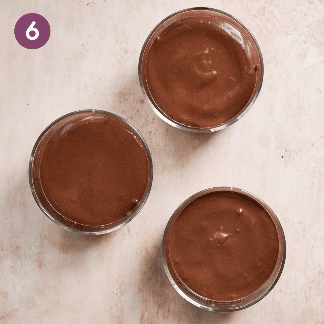 Three small ramekins of mousse on a table.