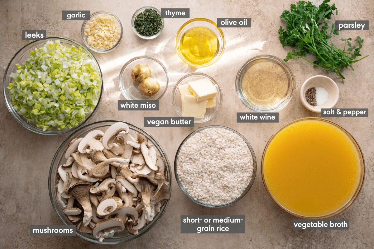 Ingredients in bowls for vegan mushroom risotto, each ingredient labeled. 