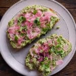 edamame smashed toast with pickled onions and microgreens.