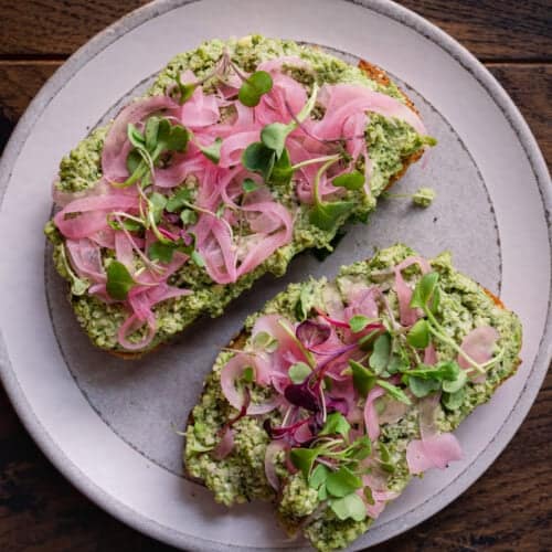 edamame smashed toast with pickled onions and microgreens.
