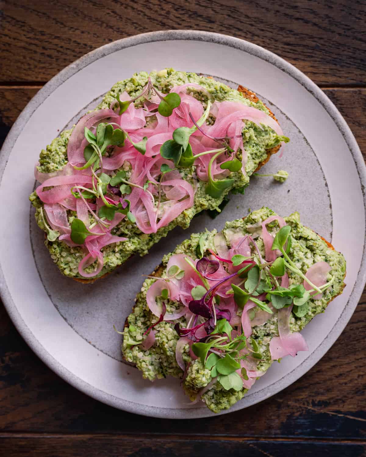 edamame smashed toast with pickled onions and microgreens.