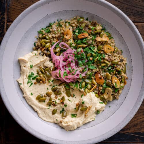 lentil quinoa bowl with pickled onions and garlic pepitas.