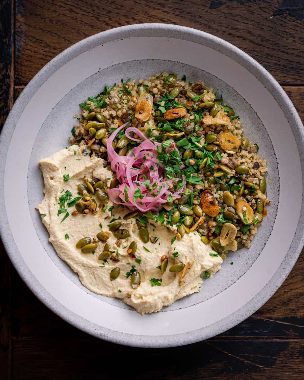 lentil quinoa bowl with pickled onions and garlic pepitas.