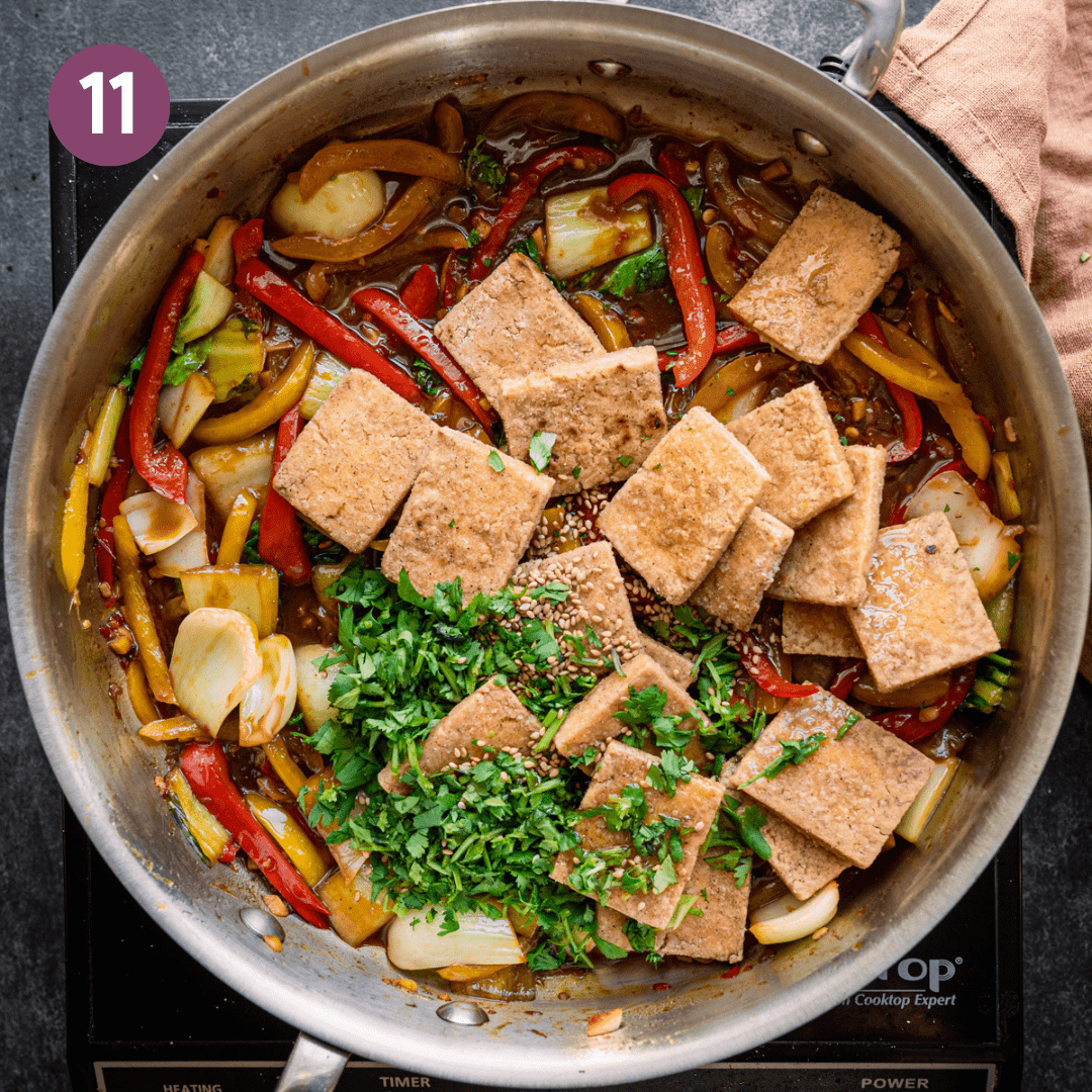 Tofu, cilantro, toasted sesame seeds and oil added into the pan.