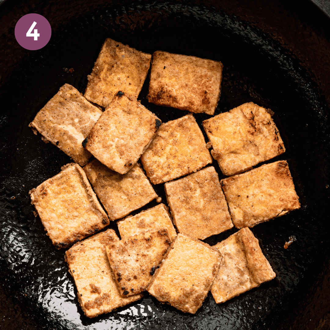 Fried tofu in a wok.