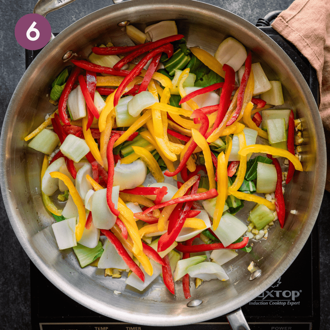 Chopped vegetables in frying pan with garlic and ginger.