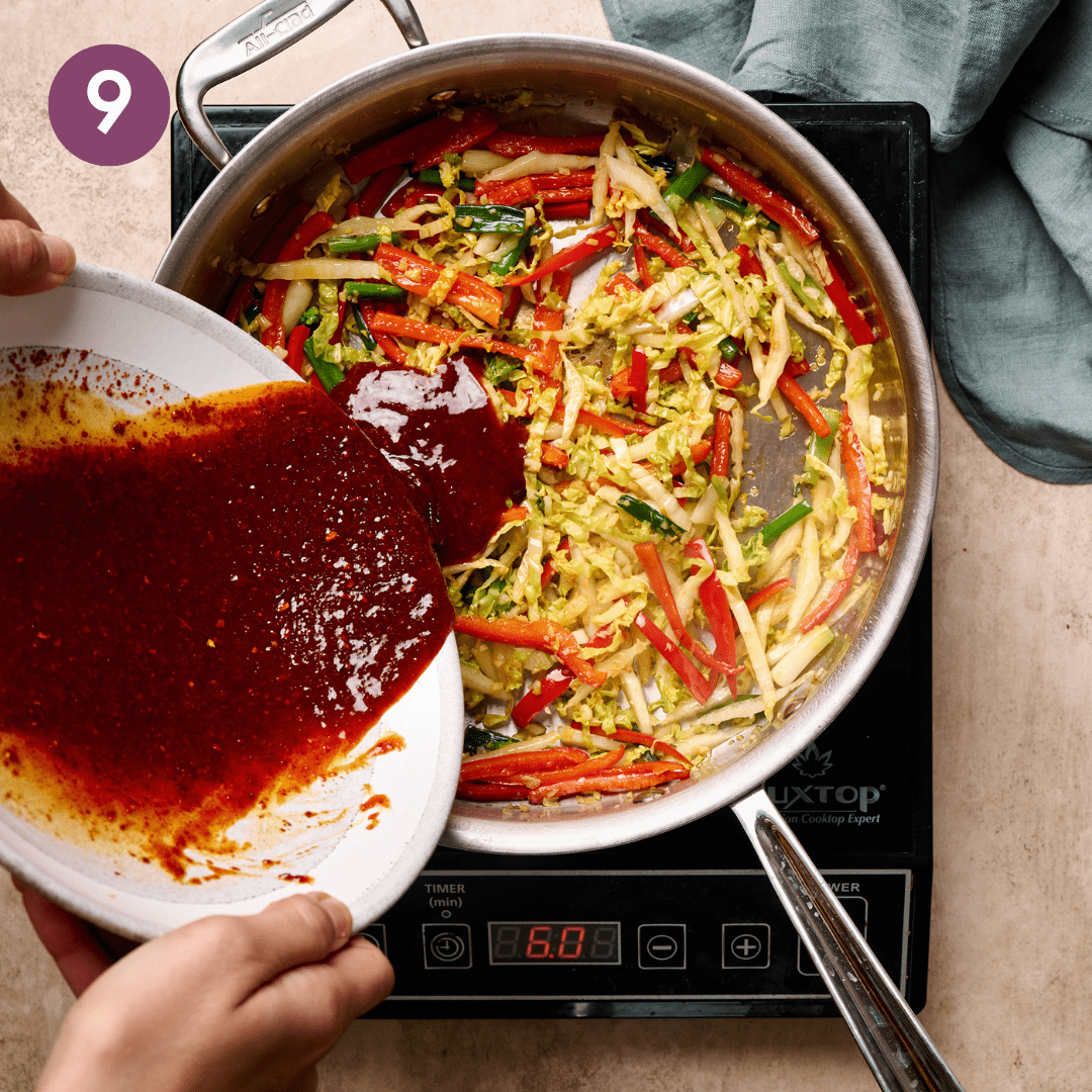 Person pouring gochujang sauced into pan.