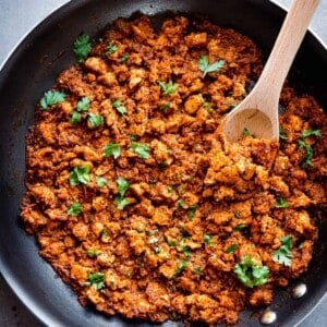 sofritas in a large pan with a wooden spoon.