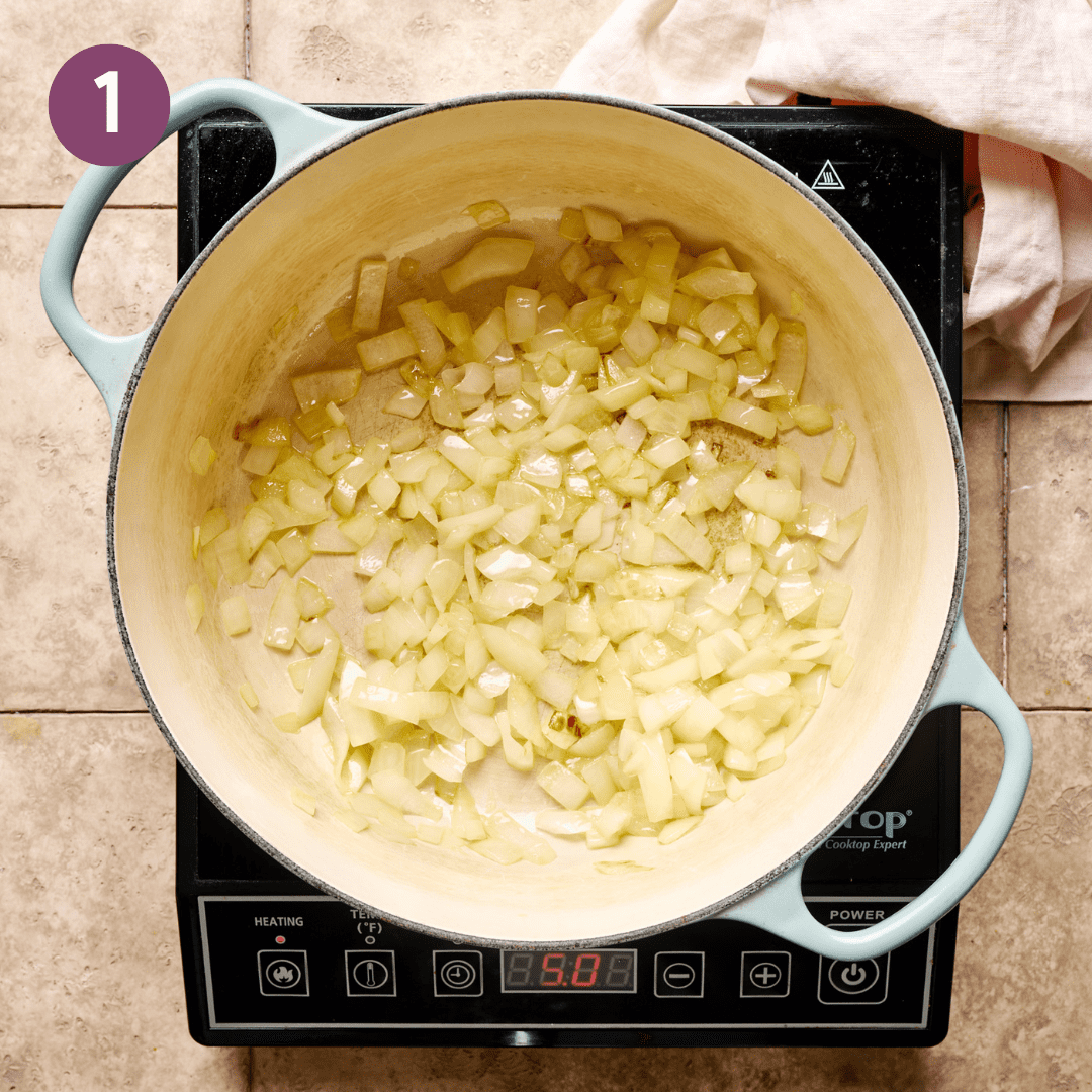 Onion and oil cooking in a large pot.