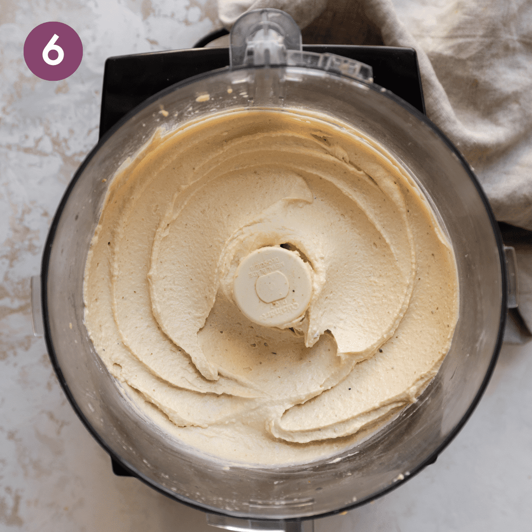 Blended hummus in food processor.