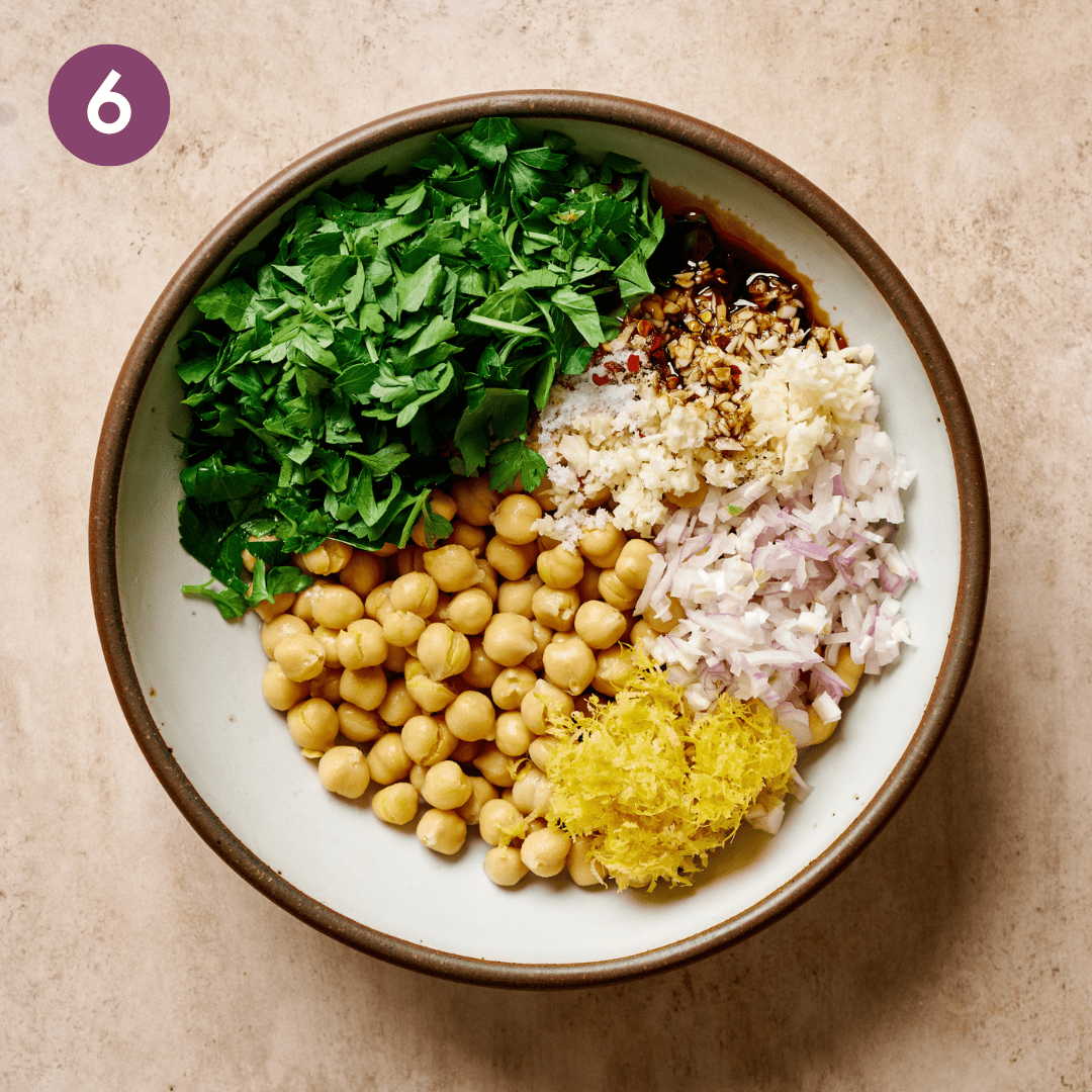 Marinated chickpea ingredients in a bowl before being combined.