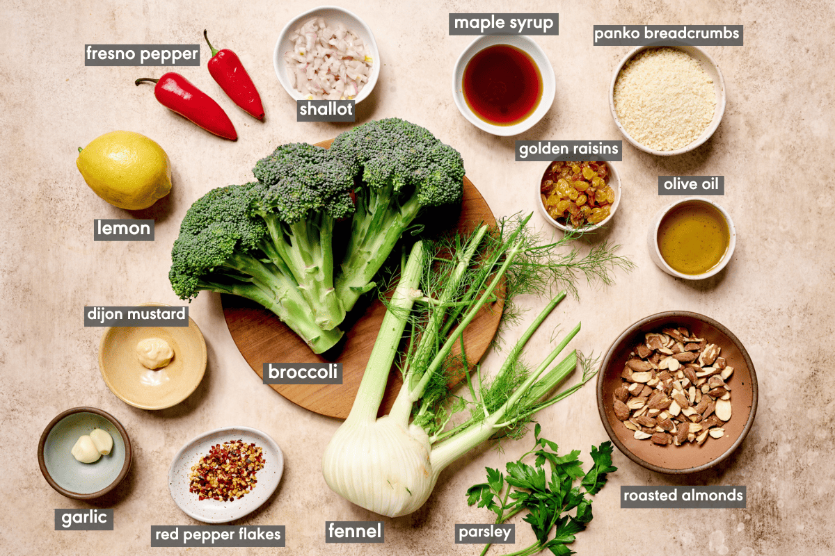 Broccoli salad ingredients laid out on a table in various bowls.