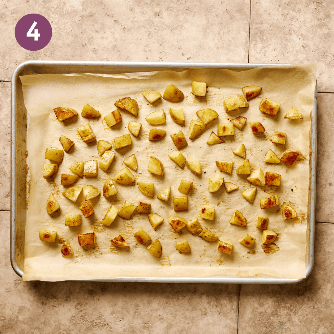 Roasted potatoes on the baking sheet.