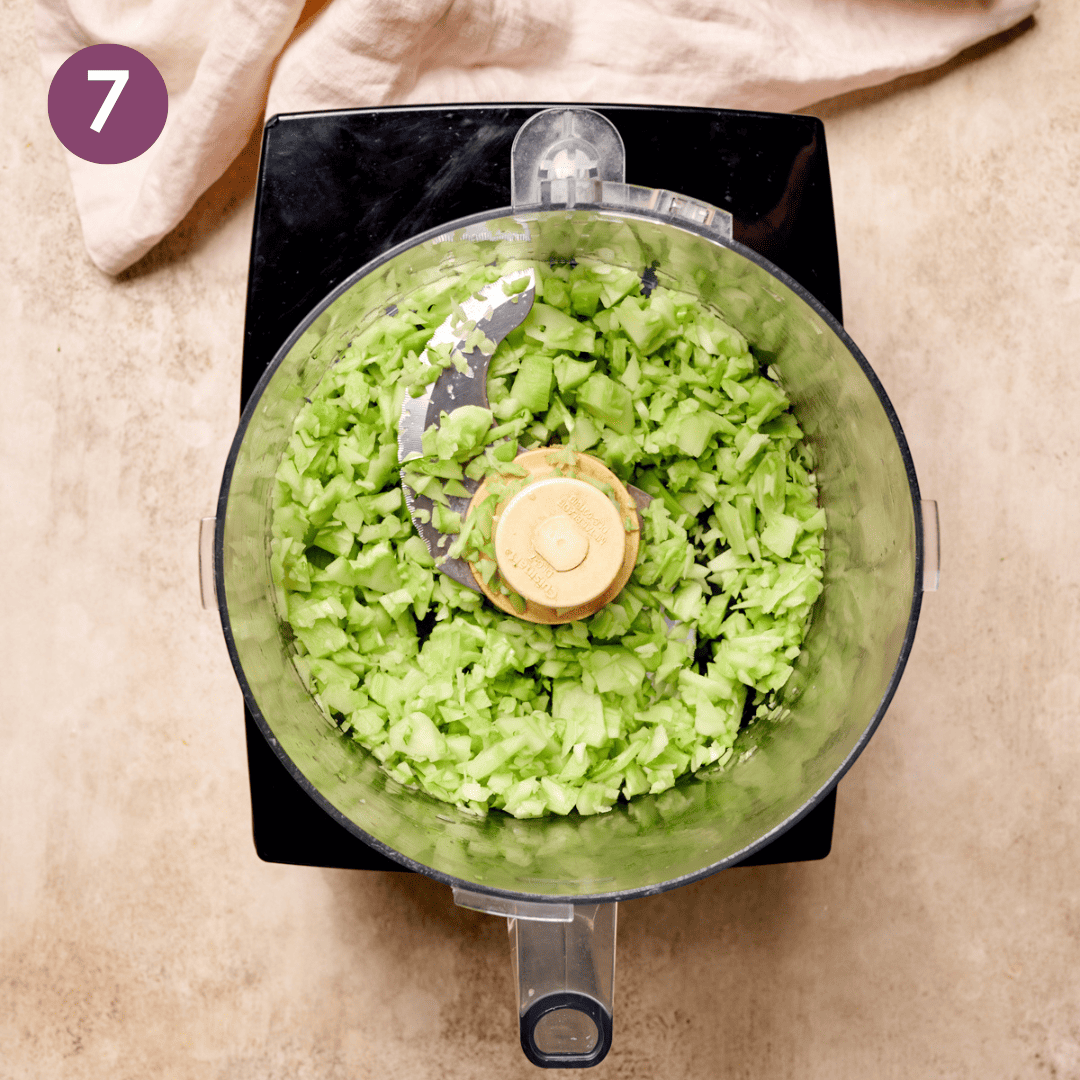 Broccoli stems and florets in a food processor.