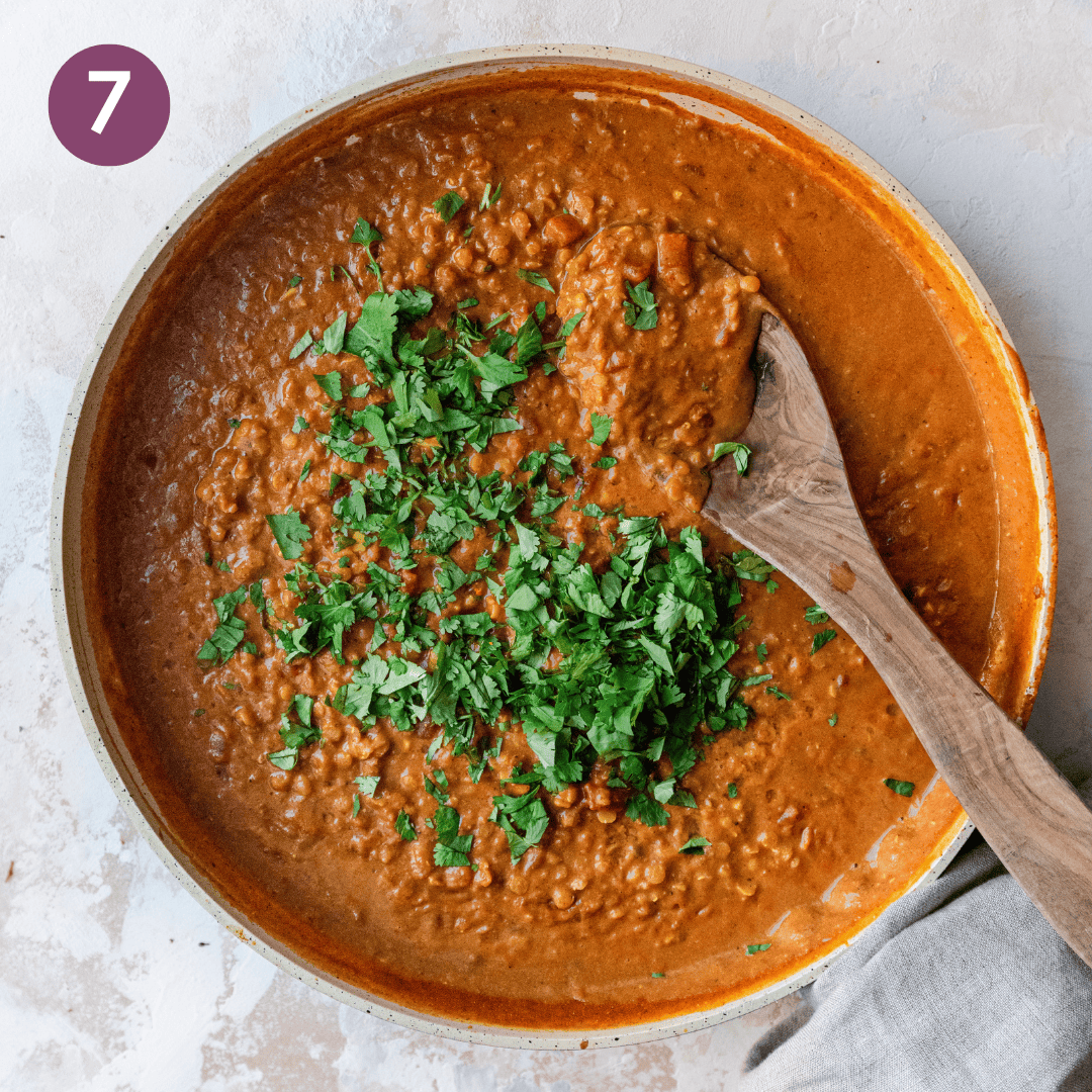 curry in skillet topped with cilantro.