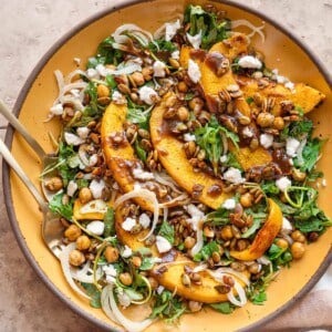 Close up of pumpkin salad on a yellow plate.