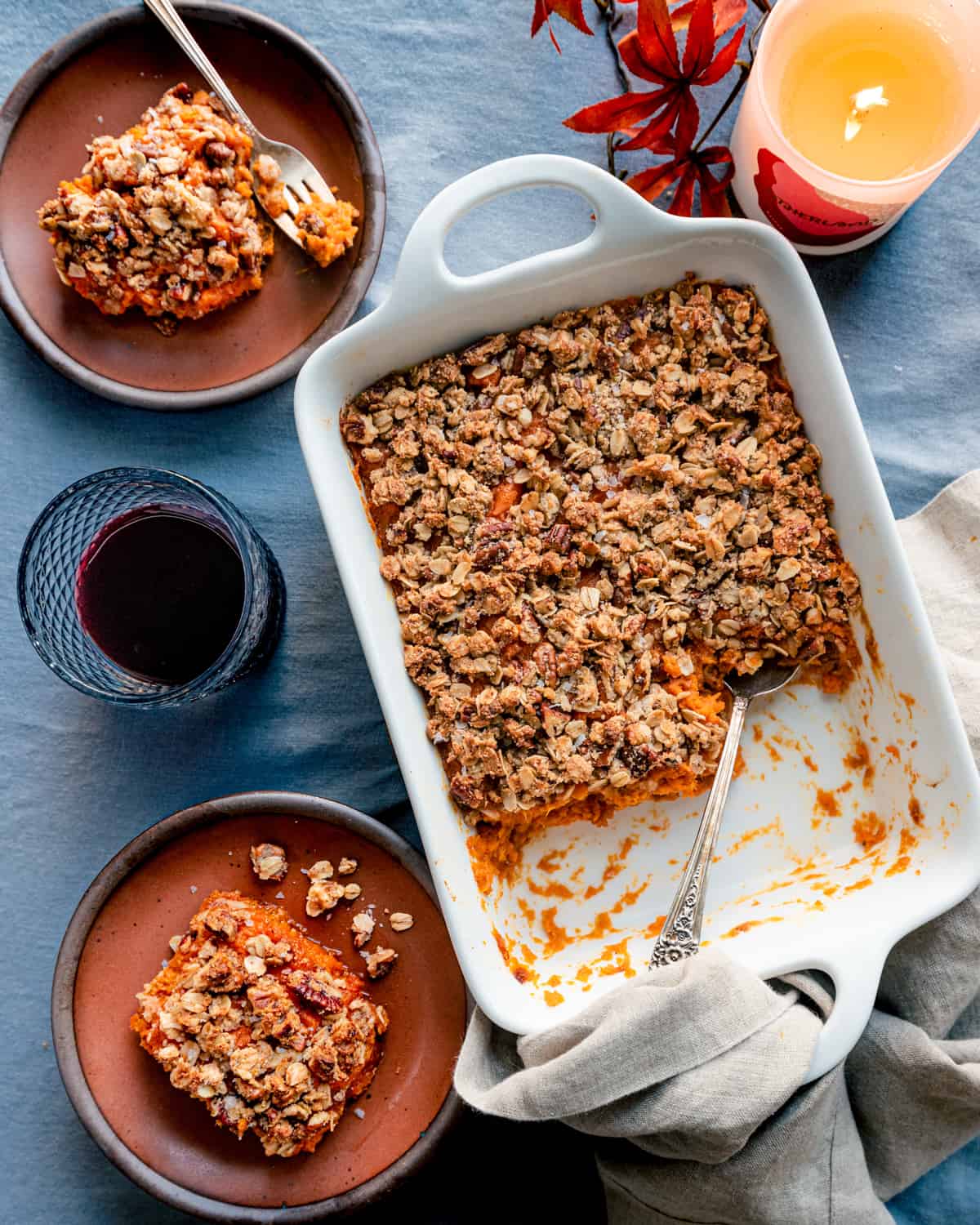 Sweet potato casserole on table with blue table covering.