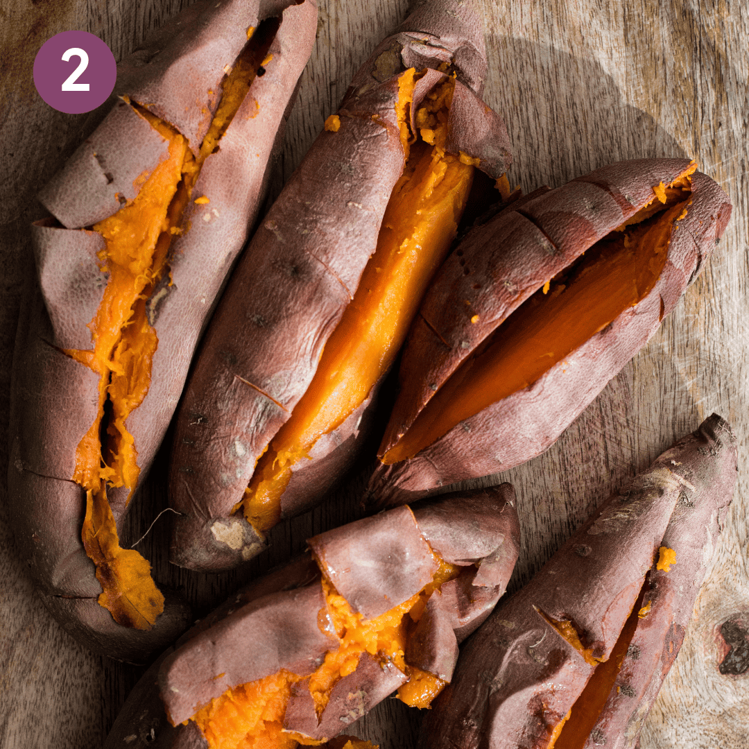 Cooked sweet potatoes sliced down the middle.