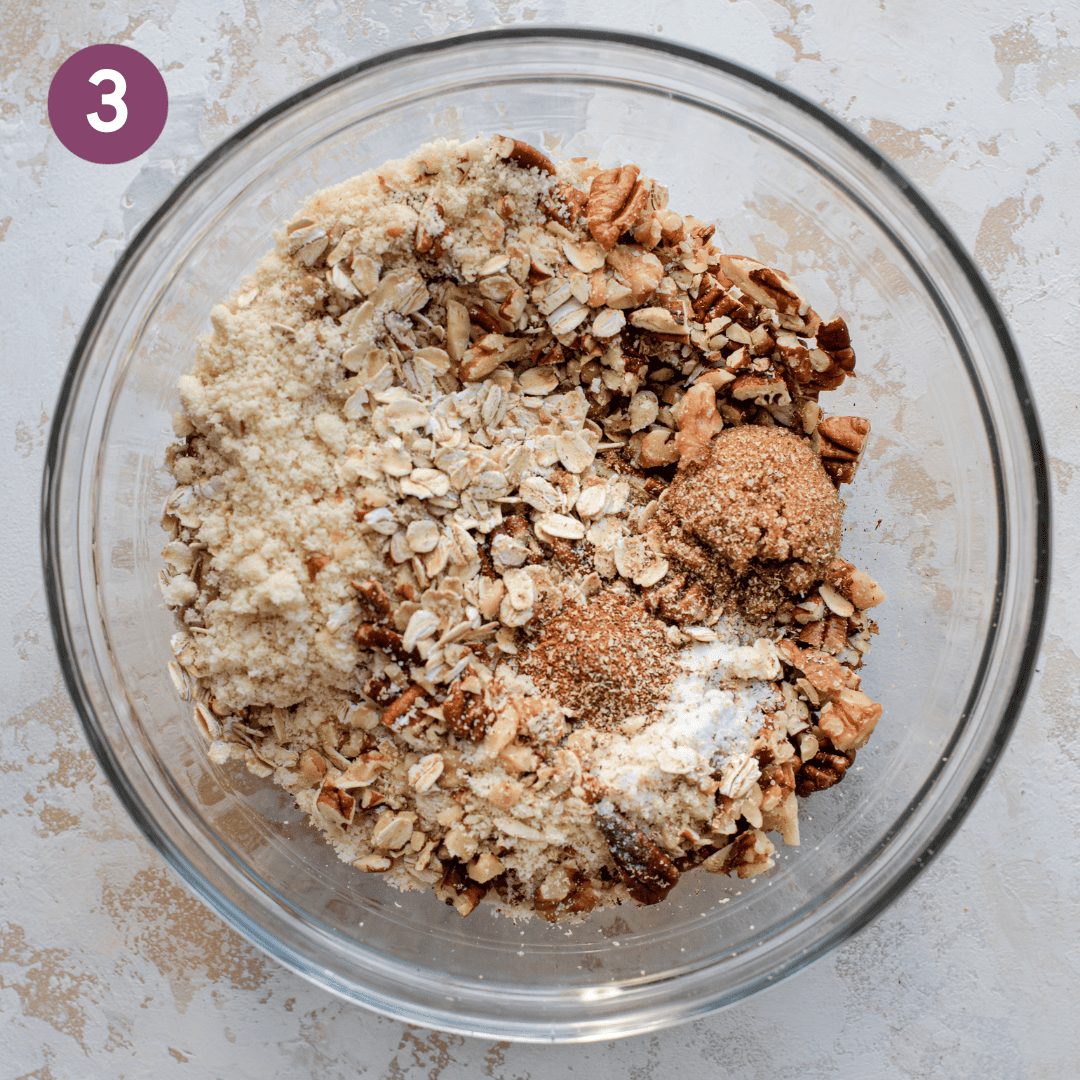 Crumble ingredients in a glass bowl before being mixed.