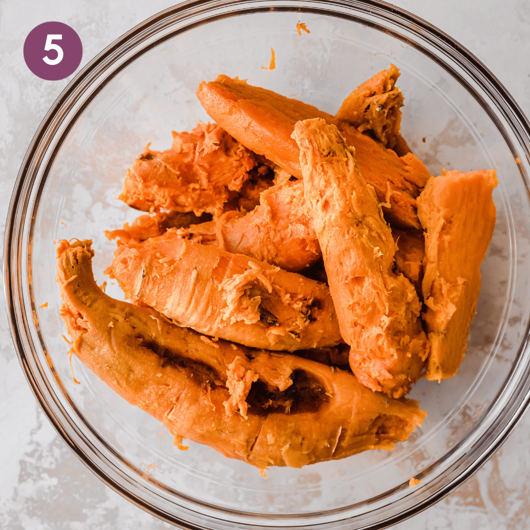 Full sweet potatoes without the skins in a large glass bowl.