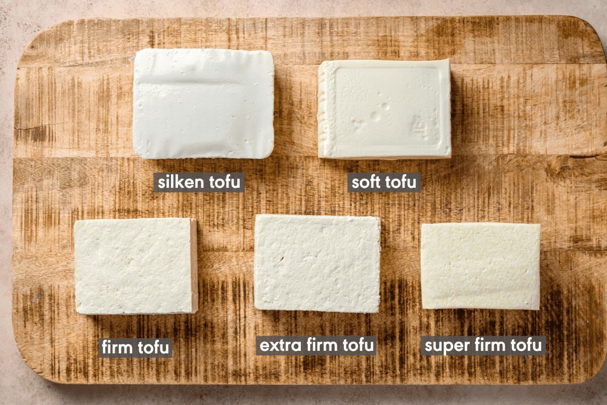five different types of tofu on a cutting board.