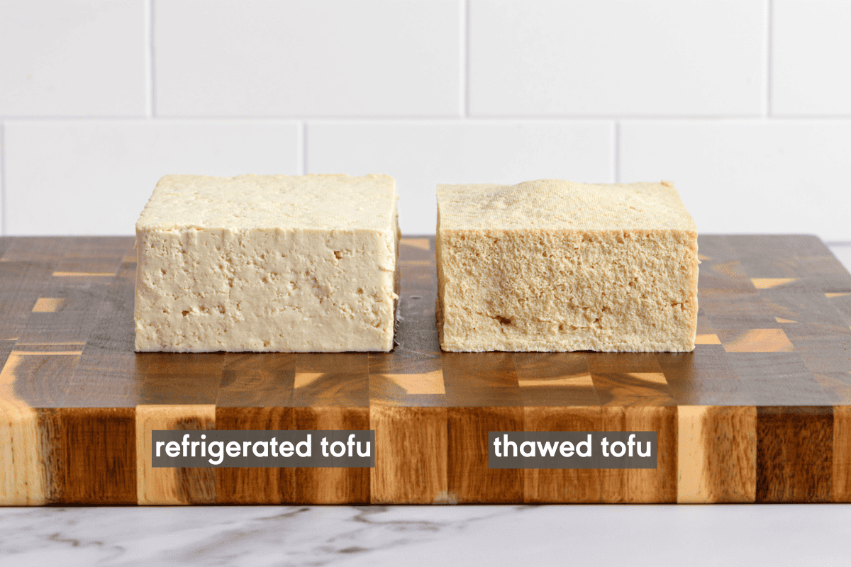 refrigerated tofu block and thawed tofu block next to each other on a cutting board.