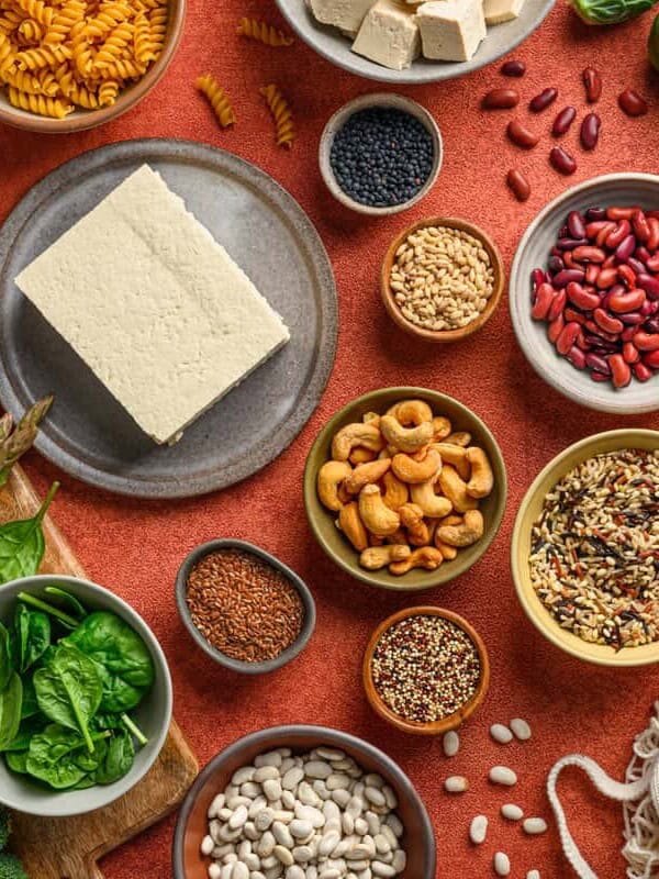 various vegan protein sources arranged on plates on a table.