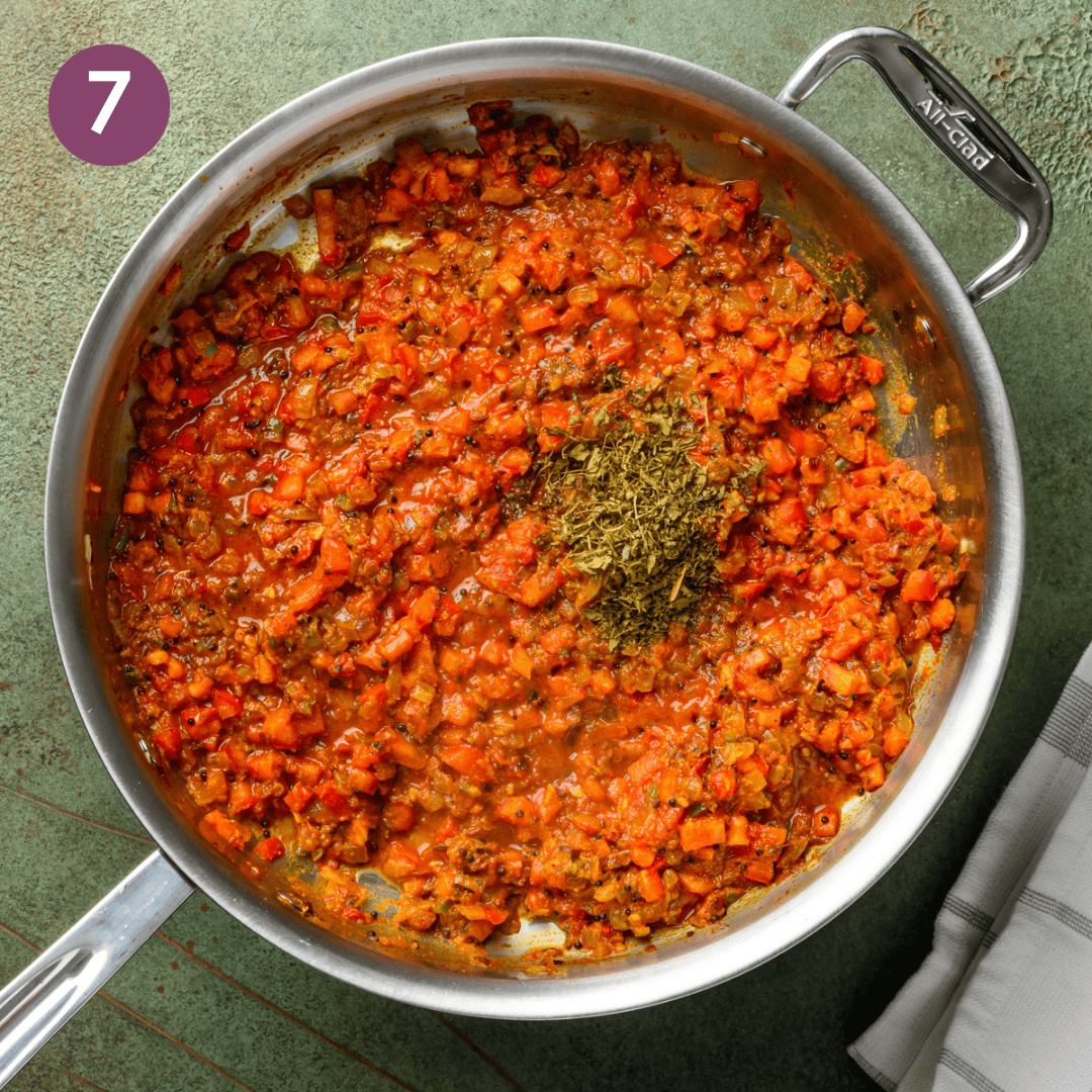 tomatoes, salt and fenugreek leaves added to aromatic mixture in pan.