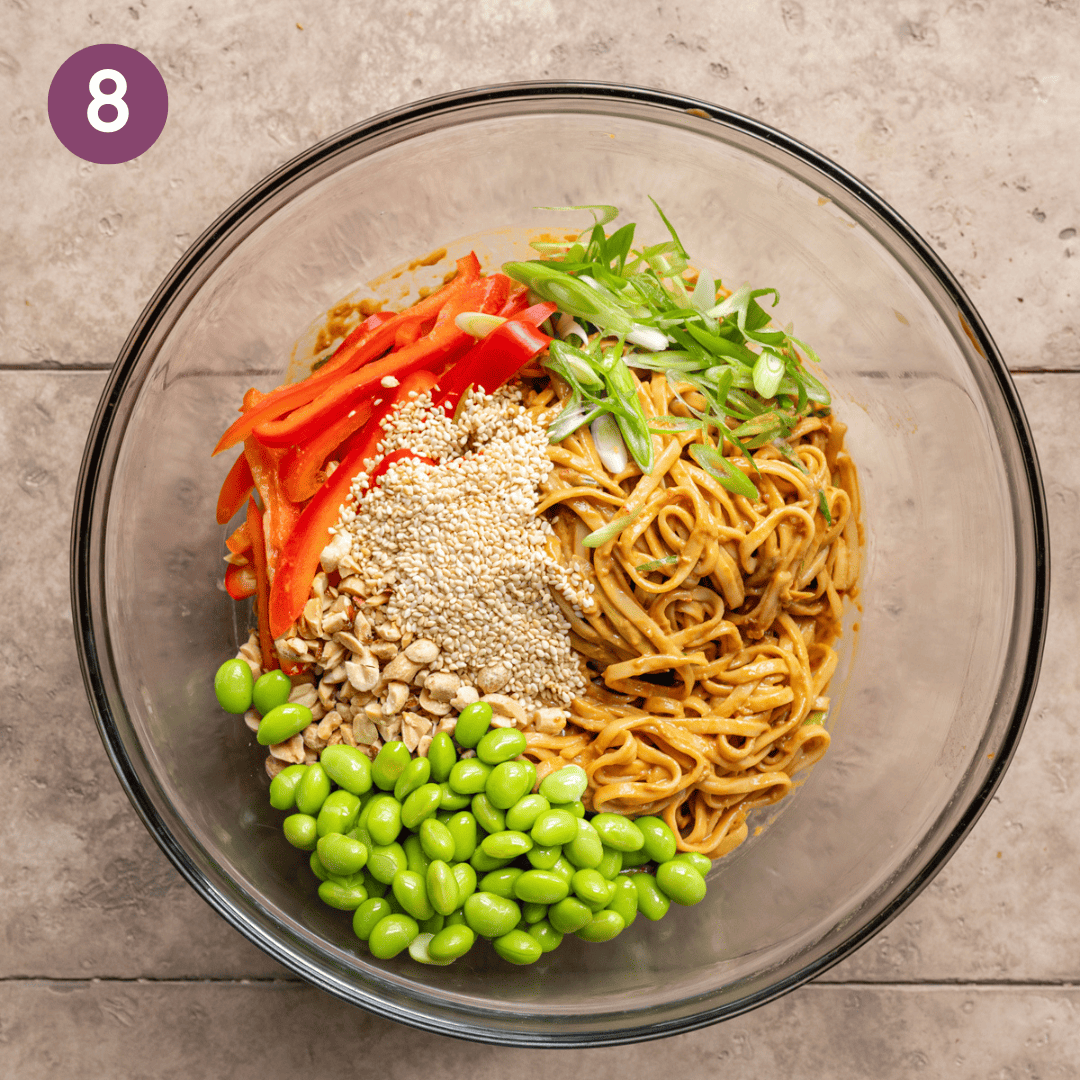 all sesame noodle ingredients combined in the glass bowl.