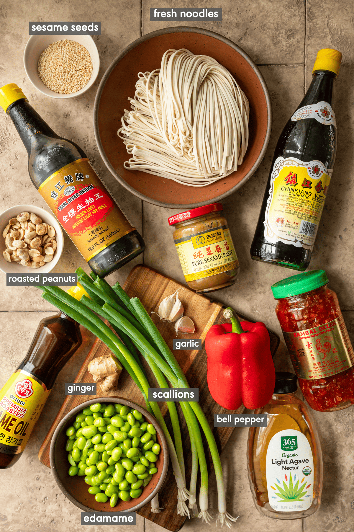 ingredients for Chinese sesame noodles on a tiled surface. 
