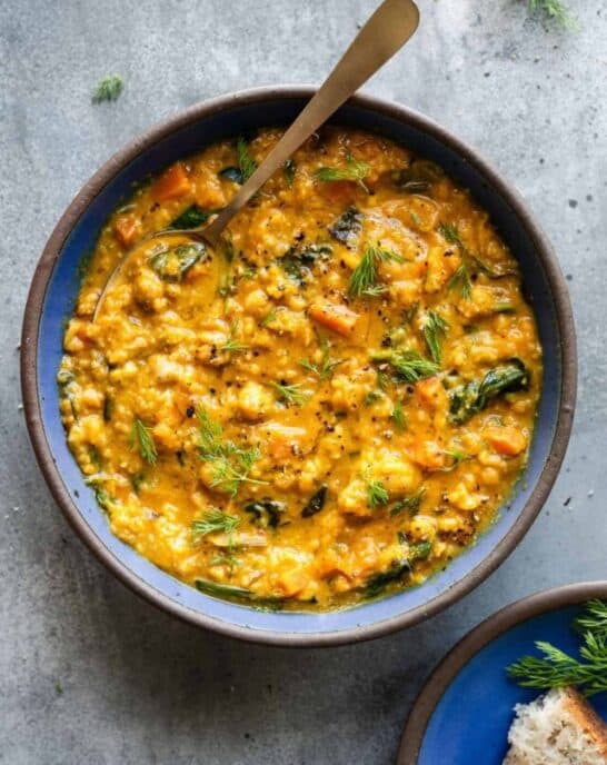 overhead photo of chickpea soup in a bowl on a table.