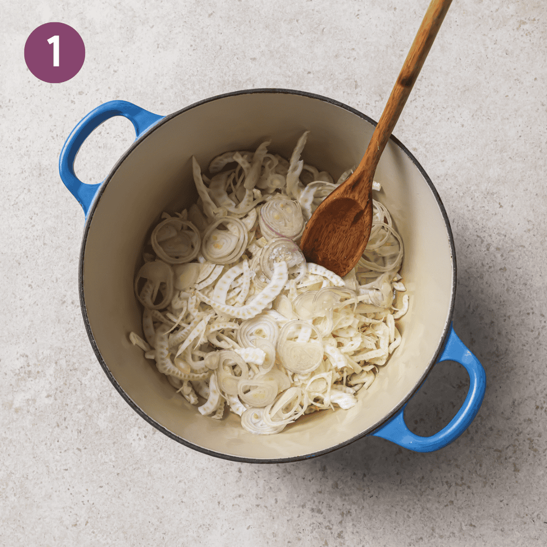 Fennel and shallot in a large pot with a wooden spoon before being cooked.