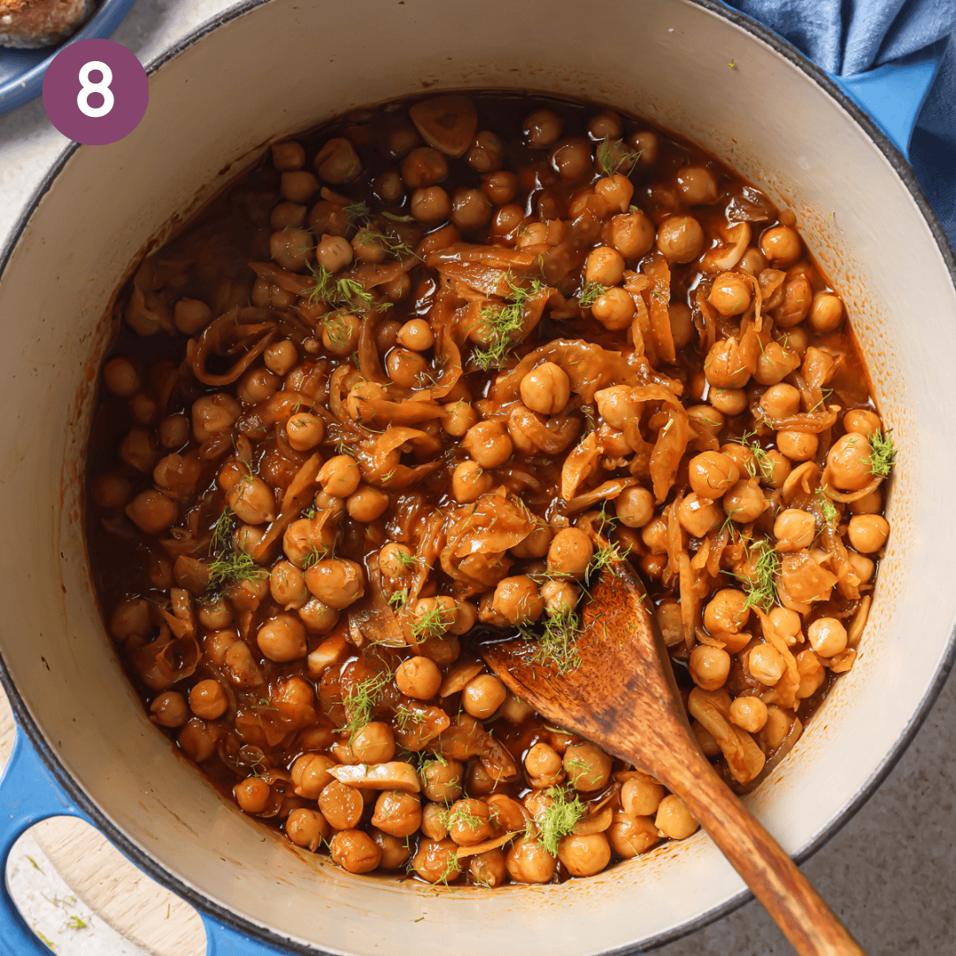 finished braised chickpea dish topped with fennel fronds.