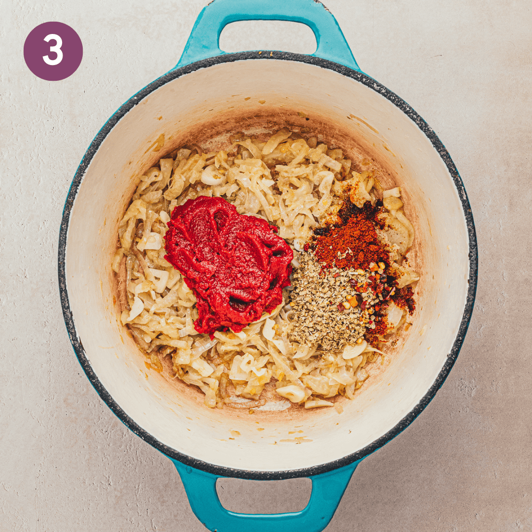 tomato paste and spices added to mixture in dutch oven.