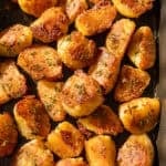 Close up photo of crispy roasted potatoes on a pan.