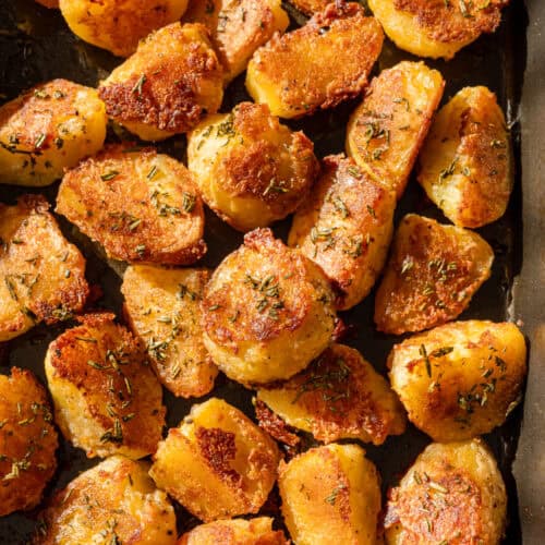 Close up photo of crispy roasted potatoes on a pan.