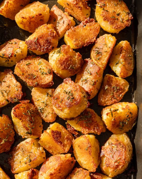 Close up photo of crispy roasted potatoes on a pan.