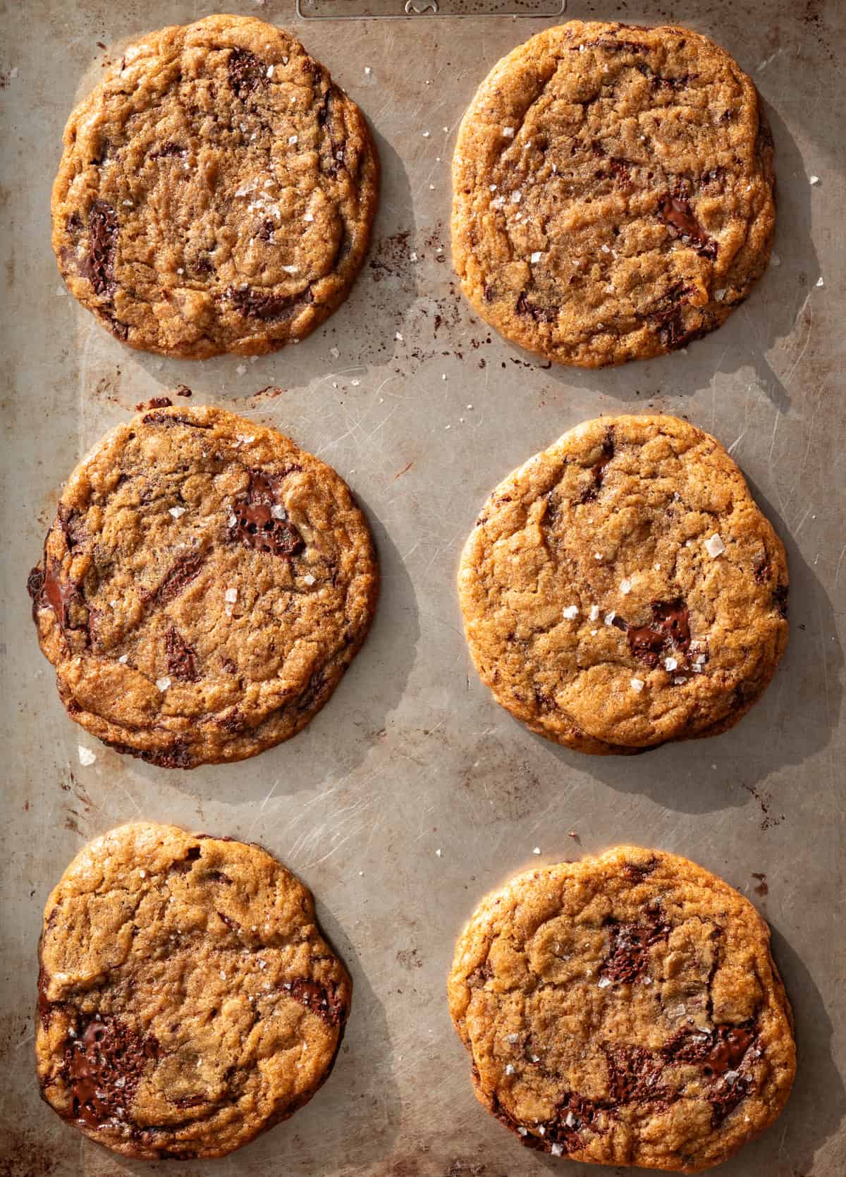 six baked cookies on baking sheet.