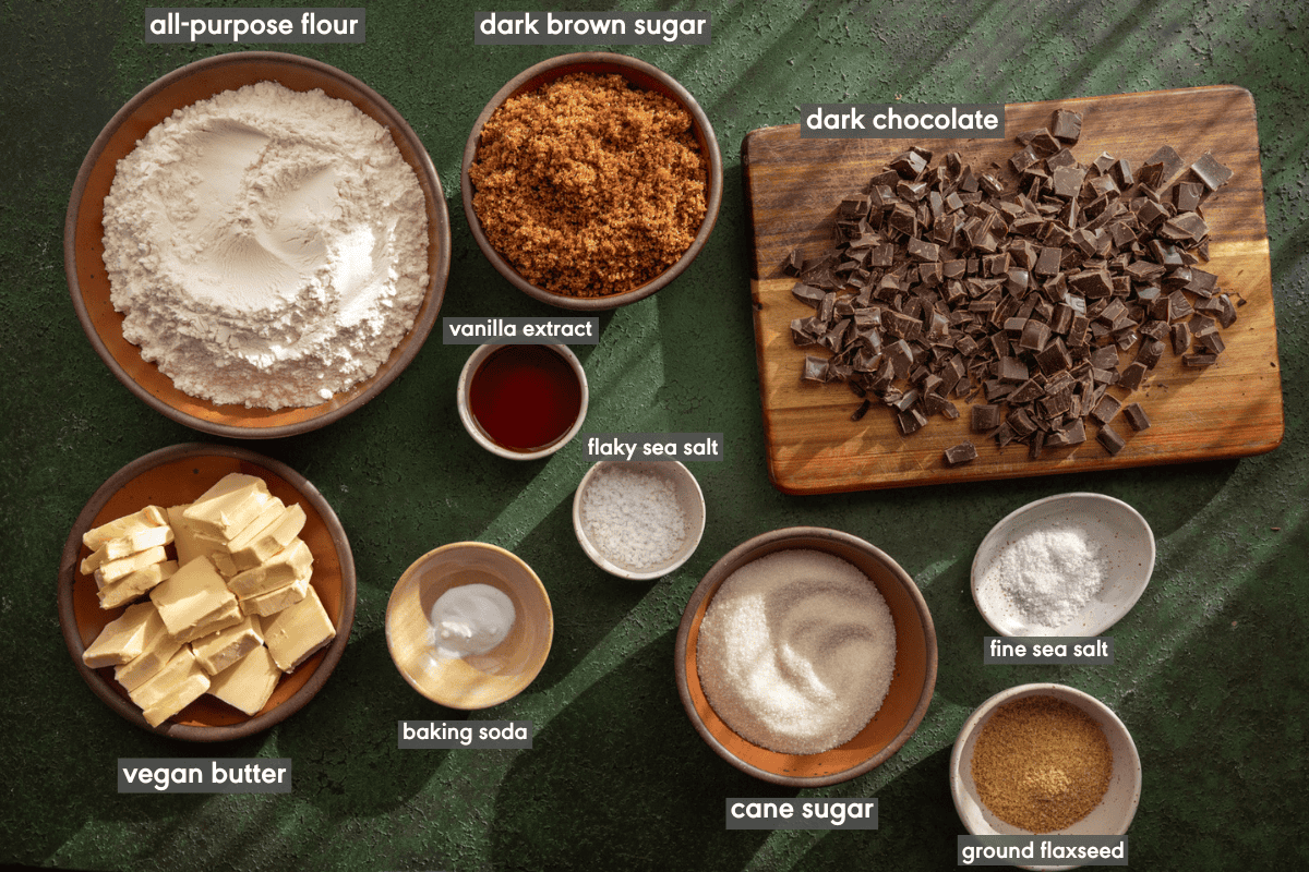 chocolate chip cookie ingredients in various bowls on a table.