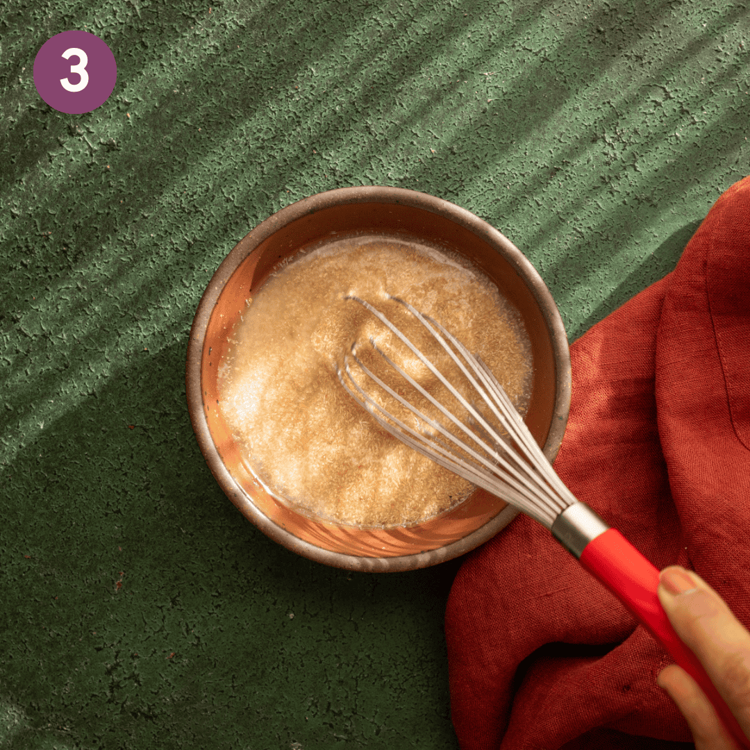 person whisking flax egg in a small bowl.