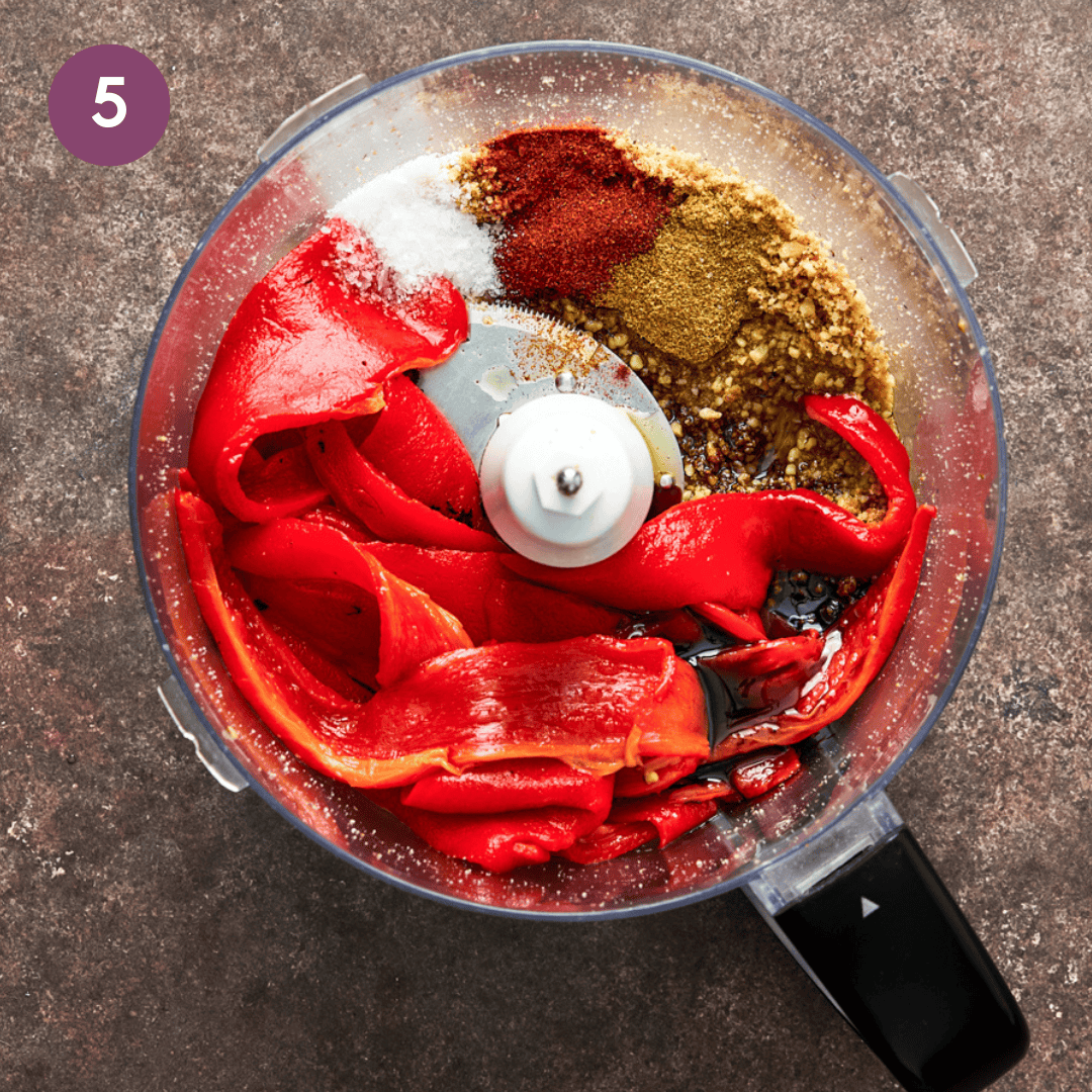 roasted red peppers, spices, walnuts, and bread crumbs in a food processor before being blended. 