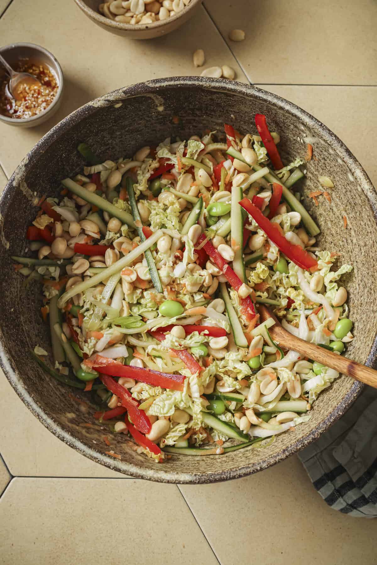 overhead view of salad with a wooden spoon.