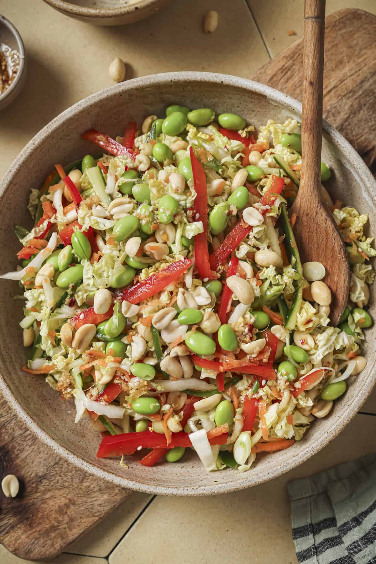 close up overhead shot of cabbage salad with a wooden spoon.