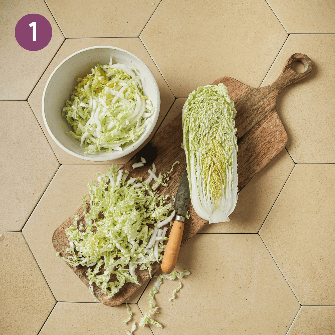 sliced napa cabbage on a cutting board.