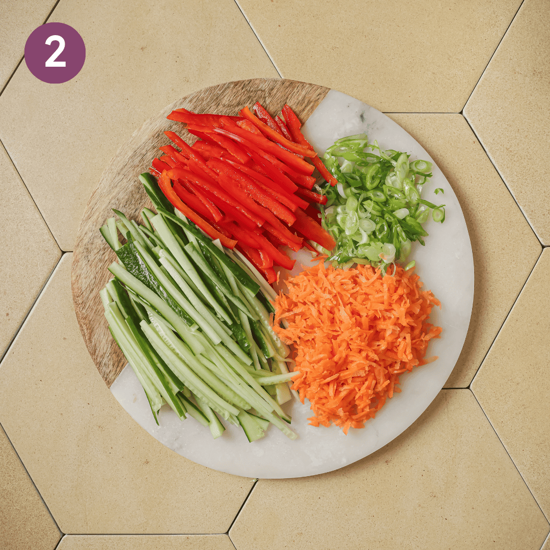 other sliced vegetables on a marble cutting board.