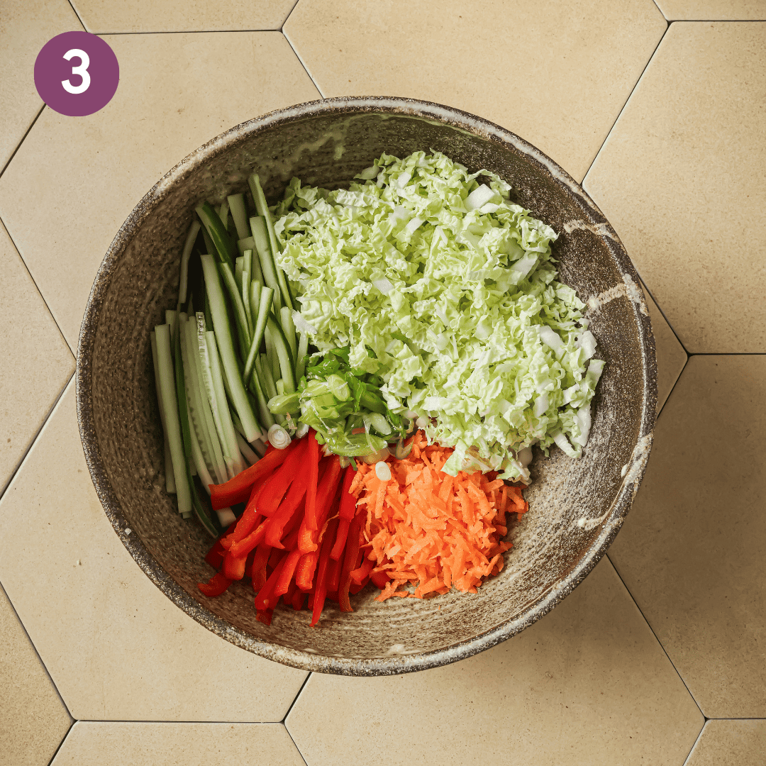 cabbage and other vegetables together in a bowl.