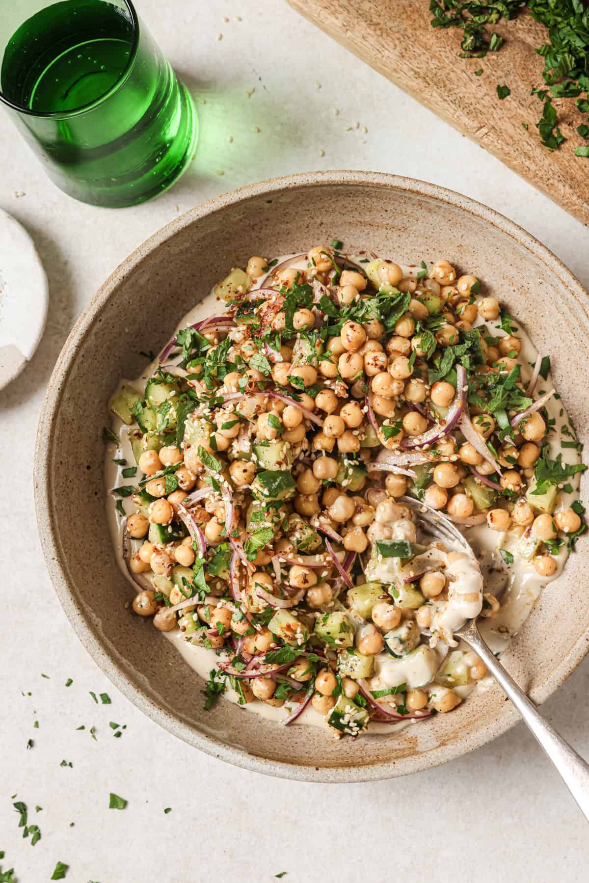 Overhead view of chickpea salad with a spoon in the bowl.