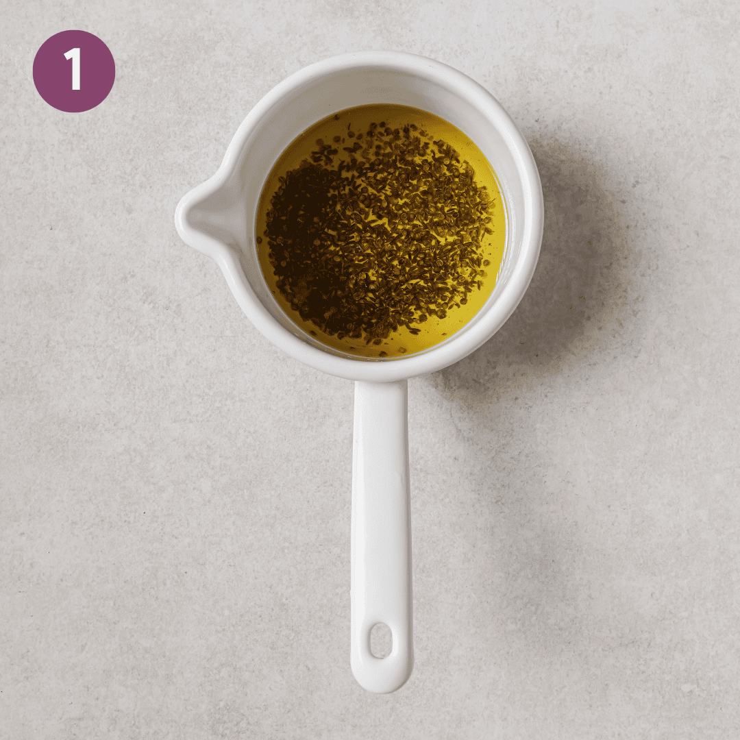 hot oil, cumin and coriander in a measuring cup.