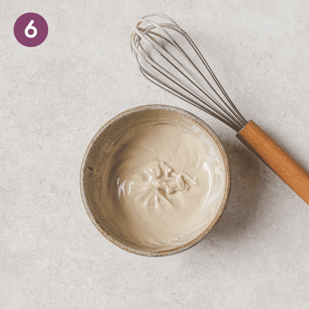 tahini dressing ingredients in a small bowl after being mixed.